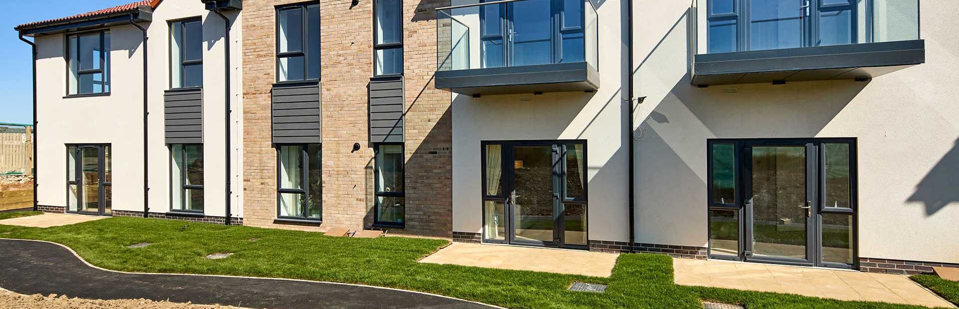 Exterior image of Filey Fields with a walk way and grass