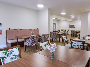 the scheme communal area with tables and chairs