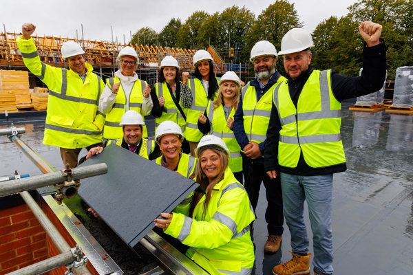Housing 21 with partners pictured standing on the roof of a new development