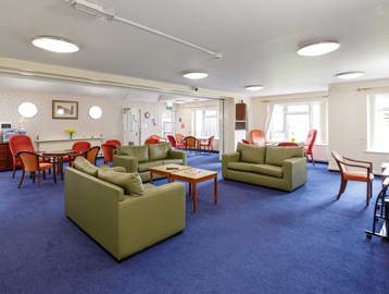 Spacious communal lounge with sofas, tables and chairs and computers