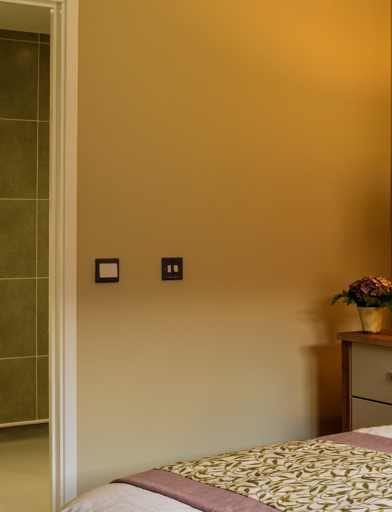 Inside the show home bedroom looking through to the bathroom from the bottom of the double bed 