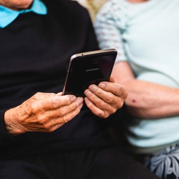A resident holds a mobile phone