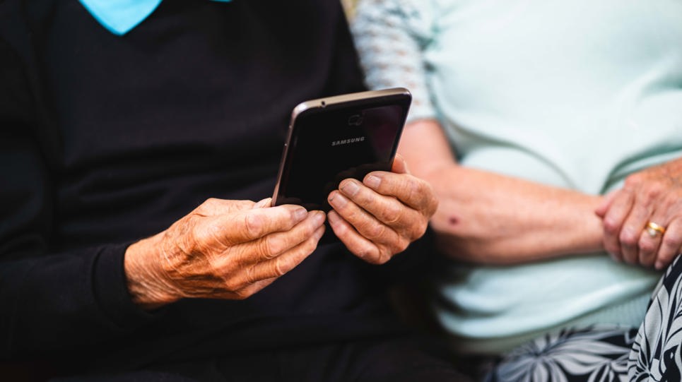 A resident holds a mobile phone