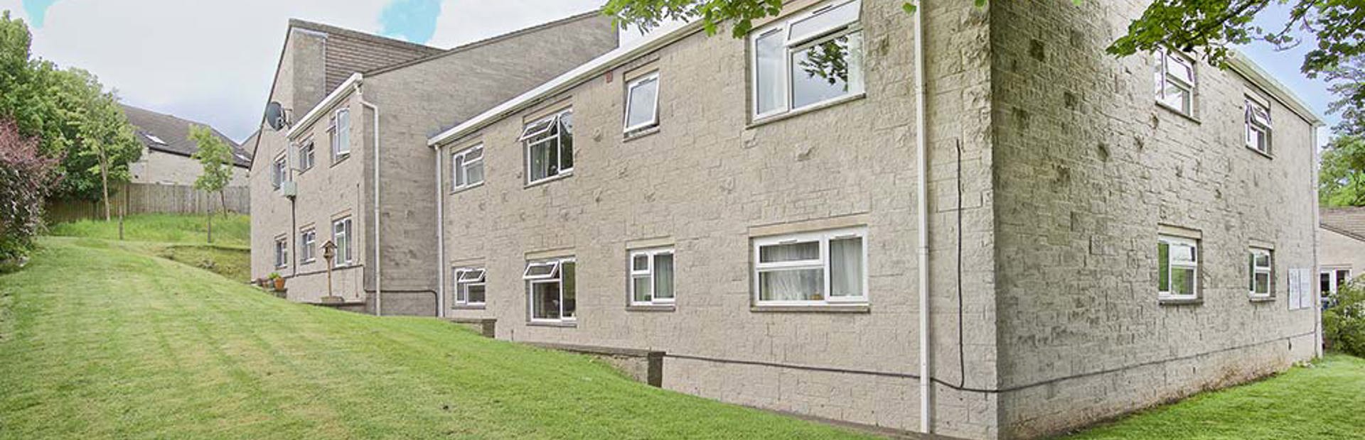 Outside of the scheme at Nicholson Court surrounded by a large grassed area