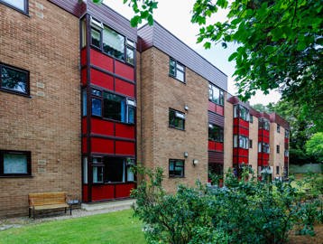 Exterior of Hildesley Court showing the brick building from the garden with greenery