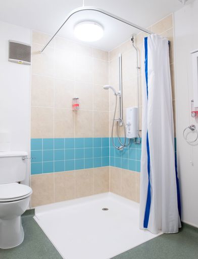 An accessible bathroom in an apartment with walk-in shower 
