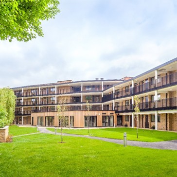 A three-storey building surrounded by gardens representing one of the schemes acquired by Housing 21 from Nottinghill Genesis