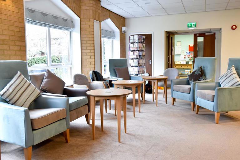 Armchairs and tables in lounge at Alan Hilton Court