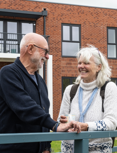 Couple enjoying the outside spaces of Fern Meadows, smiling 