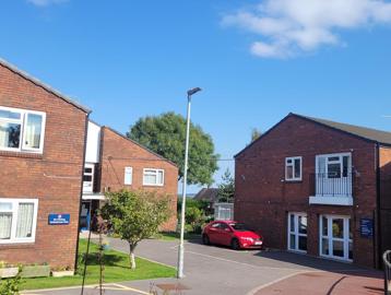 A photo of the outside area of Goodman Court with car parking spaces