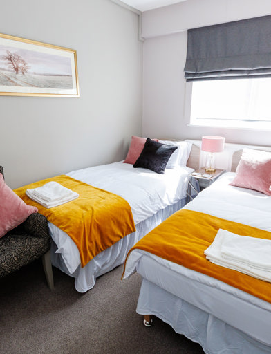 Twin beds in a small guestroom 