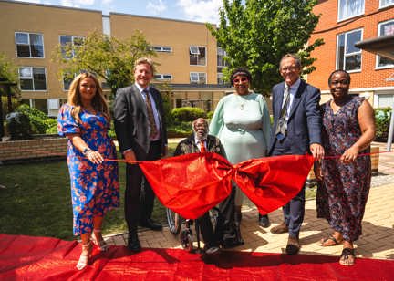 Resident Alvin ahead of the ribbon cutting with representatives from Housing 21. 