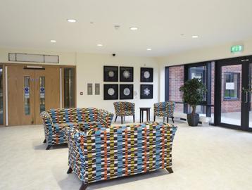Welcome entrance of Lacemaker Court with modern seating and pictures