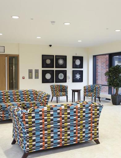 Welcome entrance of Lacemaker Court with modern seating and pictures