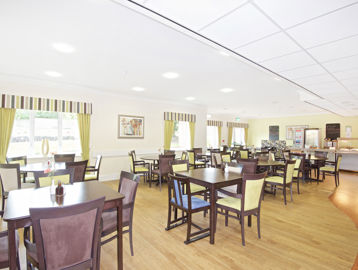 Communal dining area with tables and chairs at Alreywch Court