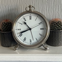 A ticking clock on a mantlepiece
