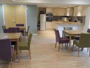 The communal kitchen and dining area at Absalom Court with tables and chairs
