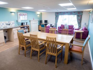 Open-plan communal lounge, kitchen and dining area for residents