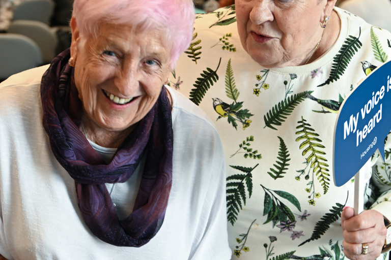 Two residents laughing and smiling at the camera