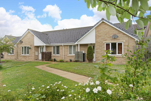 Flowers and green gardens to the front of bungalows