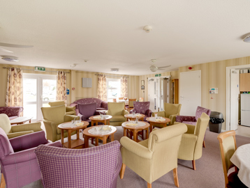 Mix of armchairs and coffee tables in the residents' lounge