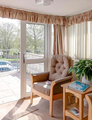 Two armchairs and a table in the lounge of an apartment 
