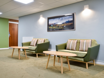 Communal seating inside Acre Court with green and blue painted walls