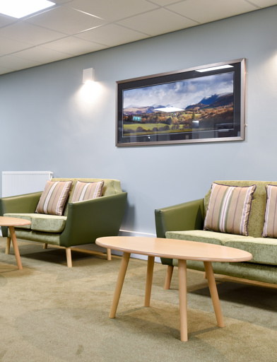 Communal seating inside Acre Court with green and blue painted walls