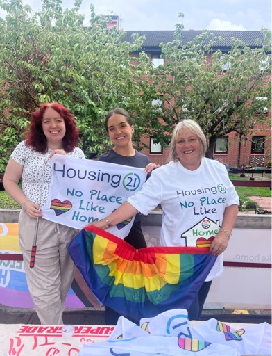 Three women holding pride flags 