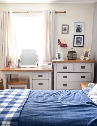 Bedroom in a resident's apartment with a double bed, storage and vanity table 
