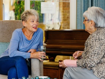 Two residents enjoying a friendly conversation