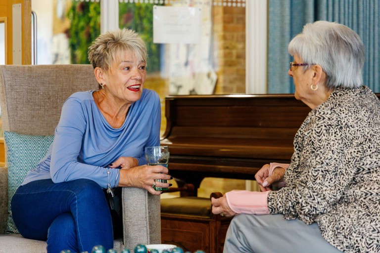 Two residents enjoying a friendly conversation