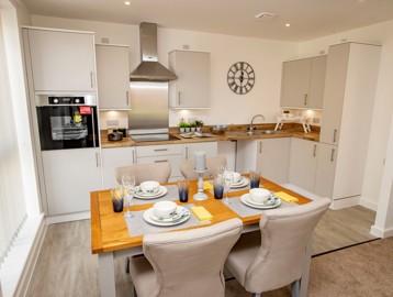 A photo of an open-plan kitchen and dining area in the show apartment