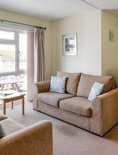 Living room area in a resident's apartment with sofas and TV 