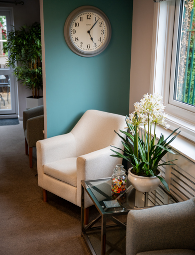 Modern sitting area with clock on the wall 