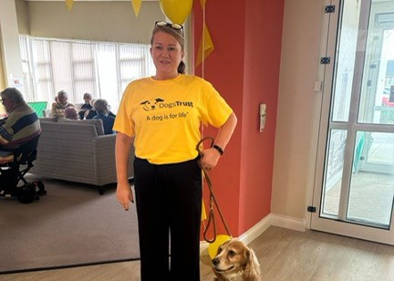 Dog sat patiently next to its human, both posing for the photo
