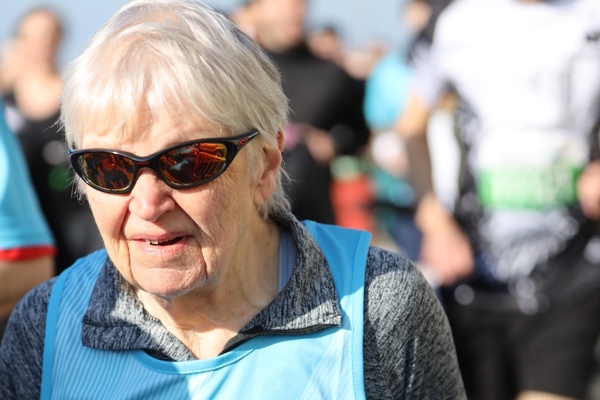 Judith's official Brighton half marathon photo - wearing a blue running bib while running