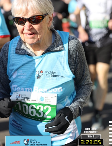Judith's official Brighton half marathon photo - wearing a blue running bib while running 