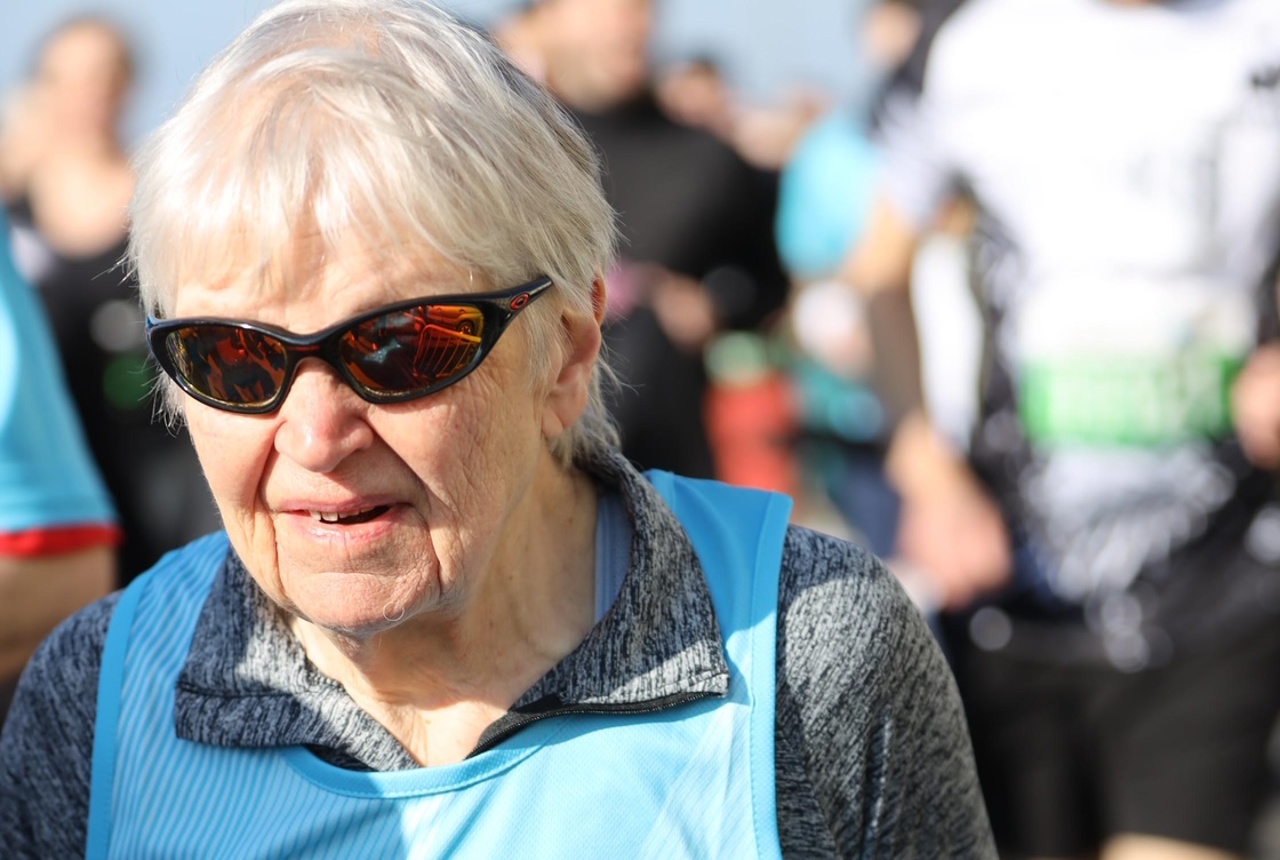 Judith's official Brighton half marathon photo - wearing a blue running bib while running