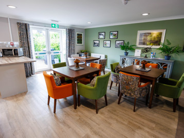 A modern and refurbished dining area with tables and chairs in a kitchen