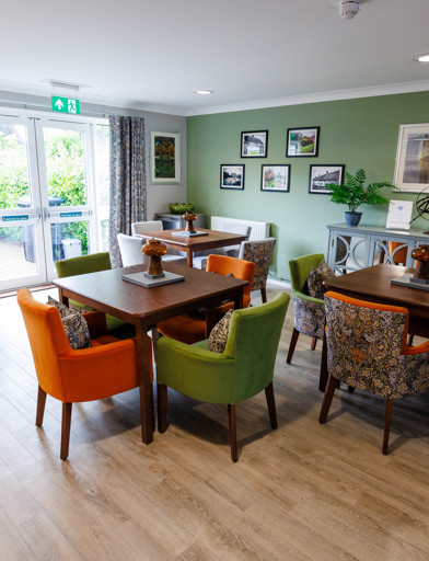 A modern and refurbished dining area with tables and chairs in a kitchen 