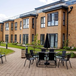 A photo of a large patio area in the gardens of Poppy Gardens with table and chairs