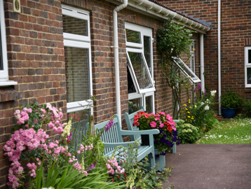 Plants and flowers outside of the scheme with benches to sit on