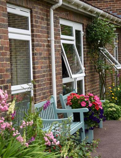 Plants and flowers outside of the scheme with benches to sit on