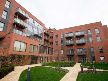 The courtyard garden area outside Foxfields with pathways and grassed sections