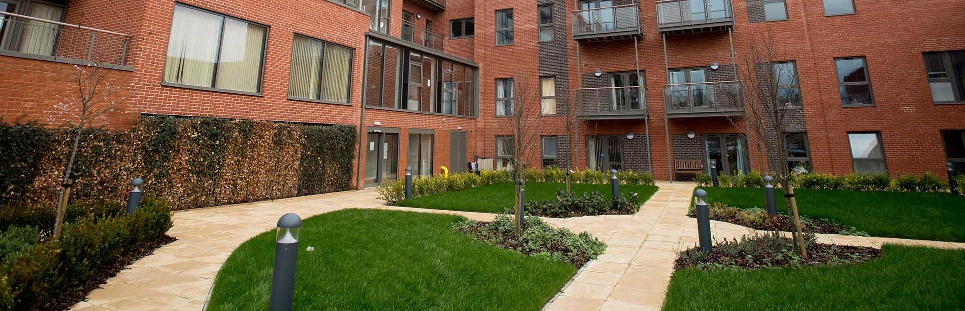The courtyard garden area outside Foxfields with pathways and grassed sections