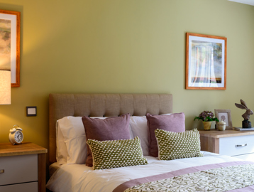 Inside the show home bedroom with double bed and side tables