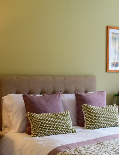 Inside the show home bedroom with double bed and side tables 