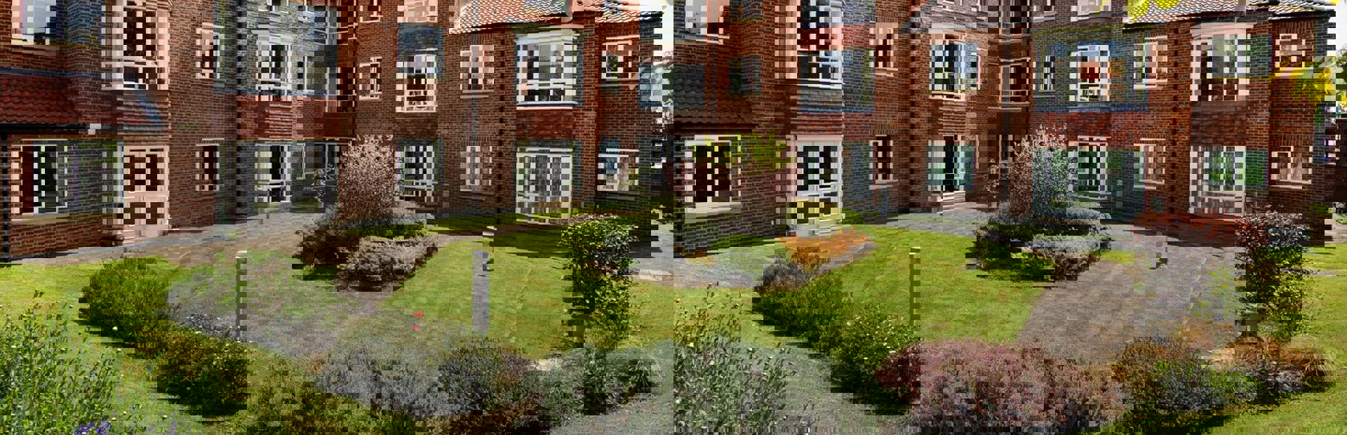 Large rear garden with plants and flowers at Springhill Court