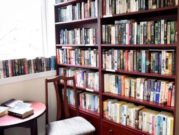 Large bookshelf in the communal library at Alan Hilton Court